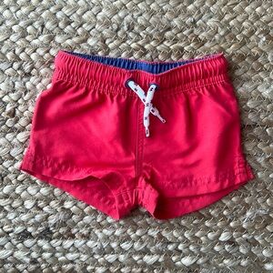 Carter’s Little Planet red swim trunks, 0-3 months
